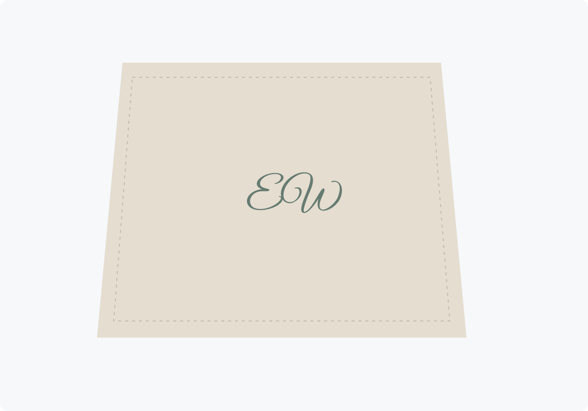 Folded fabric mockup with small green EW script initials and a stitched-looking border